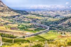 S-Curve highway overpass in a scenic valley near Segesta, Sicily, Italy. Tilt-shift effect applied
