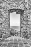 Ancient window among ruins of an old castle with seascape