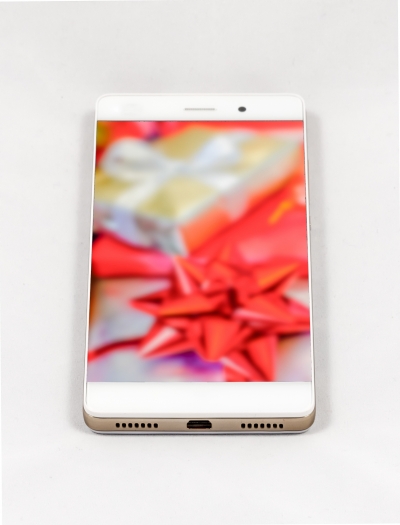 Modern smartphone with full screen picture of Christmas gifts