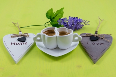Breakfast composition of two espresso cups and flower