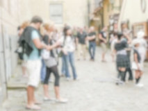Defocused background of people walking in Prague