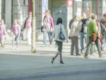 Defocused background of people walking in central Warsaw, Poland