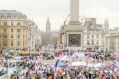 Defocused background of a crowded Trafalgar Square in London
