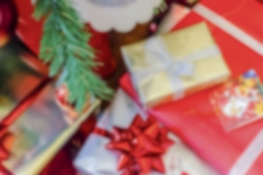 Defocused background of Christmas gifts with red packages