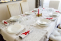 Defocused background of a red and white Christmas table setting