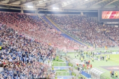 Defocused background with supporters in the stadium for football match