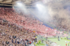 Defocused background with supporters in the stadium for football match