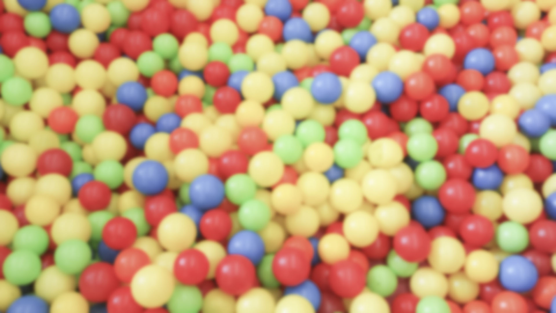 Defocused background with colorful plastic balls in children's playground pool