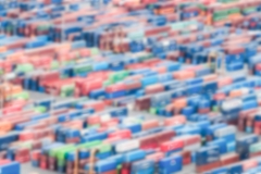 Defocused background of shipping containers stacked on a commercial port