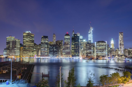 Scenic view at night of modern skyscrapers in lower Manhattan, New York City, USA. Concept for business, finance, real estate