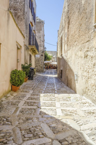 Stone paved ancient medieval street in the town of Erice, Sicily, Italy