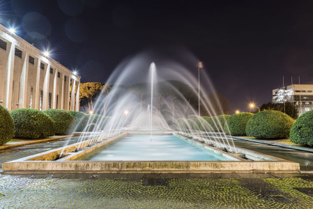 Scenic fountain, iconic neoclassical architecture in the EUR district, Rome, Italy