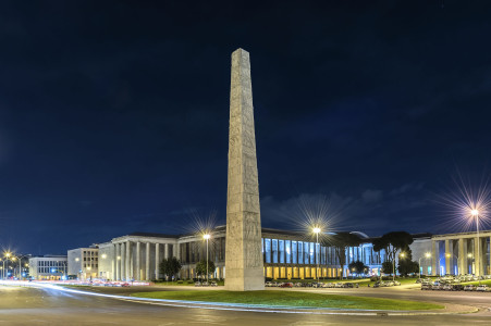 Night view of the Marconi obelisk, iconic landmark in the EUR district, Rome, Italy
