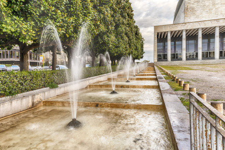 Scenic fountain, iconic neoclassical architecture in the EUR district, Rome, Italy