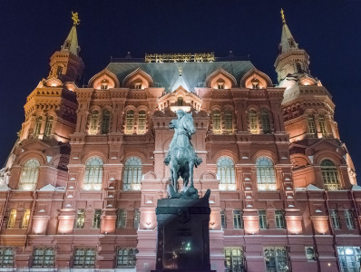 The State Historical Museum and Marshal Zhukov statue at night, Moscow, Russia
