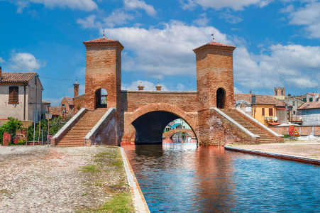 View over the Trepponti Bridge, a masonry arch bridge and iconic landmark in Comacchio, Italy
