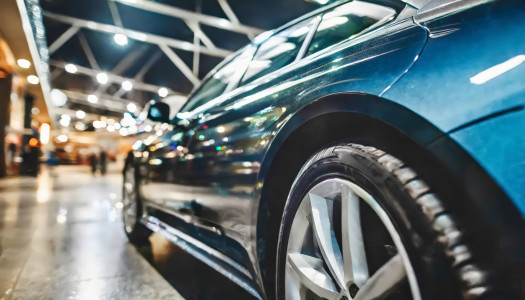 Shiny modern vehicle parked on a city street at night with a store backdrop. AI-generated content