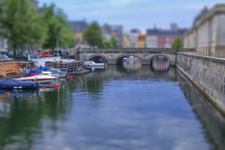 Cityscape with canal in Copenhagen, Denmark. Tilt–shift effect applied